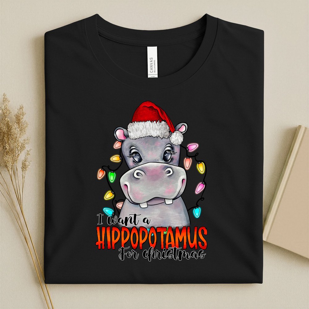 Bella Canvas Black t-shirt with a christmas hippo design and text I want a hippopotamus for Christmas